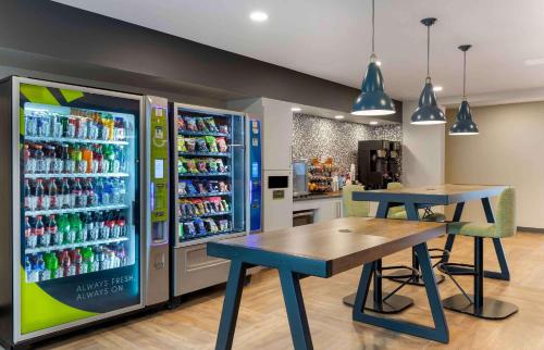 un negozio con due tavoli e un frigorifero con bibite di Extended Stay America Premier Suites - Austin - Austin Airport ad Austin