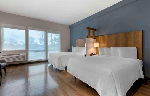 a hotel room with two beds and a window at Extended Stay America Premier Suites - Austin - Austin Airport in Austin