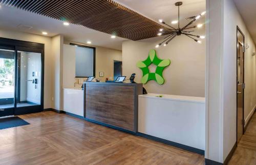 an office with a reception desk with a green star on the wall at Extended Stay America Premier Suites - Port Charlotte - I-75 in Port Charlotte