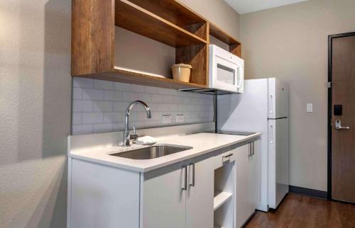 a kitchen with a sink and a white refrigerator at Extended Stay America Premier Suites - Port Charlotte - I-75 in Port Charlotte