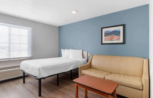 mały pokój z łóżkiem i kanapą w obiekcie Extended Stay America Select Suites - Omaha - Southwest w mieście Omaha