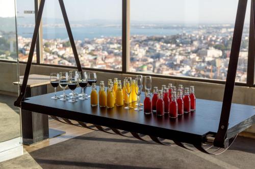 a table with wine glasses and wine bottles at Sheraton Lisboa Hotel & Spa in Lisbon