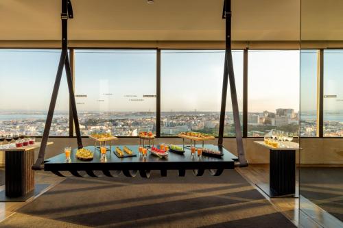 a table of food in a room with a view at Sheraton Lisboa Hotel & Spa in Lisbon