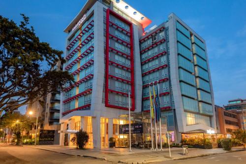 a tall red and white building on a city street at Four Points By Sheraton Bogota in Bogotá