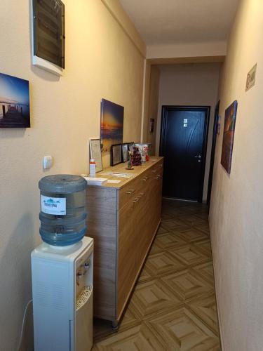 a office with a desk with a trash can and a door at Sunshine in Gevgelija