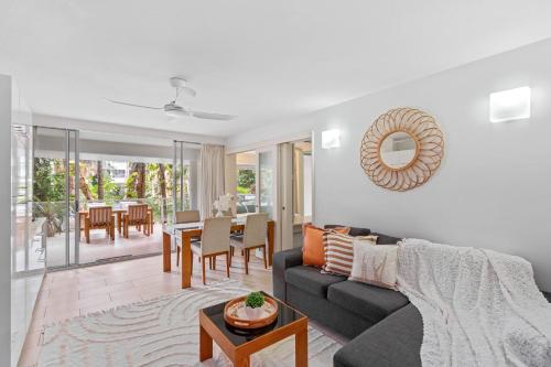 a living room with a couch and a table at Belle Escapes Drift Beachfront Resort Pool View Suite 4106 in Palm Cove
