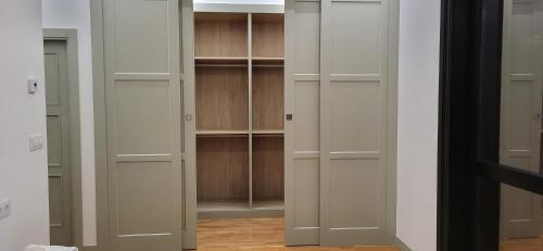 a walk in closet with white doors and shelves at Dorneda 57 in Oleiros