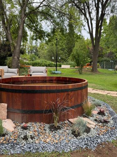a fire pit in the middle of a garden at Terra Campo Posada in Chacras de Coria