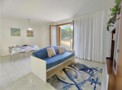 a living room with a blue couch and a table at Maison Peschiera in Sirolo
