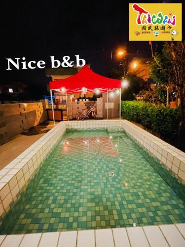 a swimming pool with a red tent in the background at 充電樁 羅東好民宿Cloud BnB 3 雲朵朵3館 近週三清溝 免費洗衣機 烘衣機 星巴克咖啡豆 國旅特約店 in Yilan City