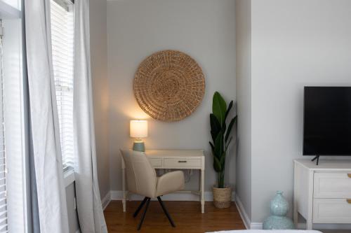 a room with a desk with a chair and a television at Cozy Beach House (4 min walk) w/Pool + Fast WiFi in Panama City Beach