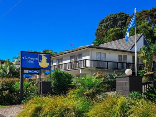 a sign in front of a house with a building at The Captains Motel in Russell