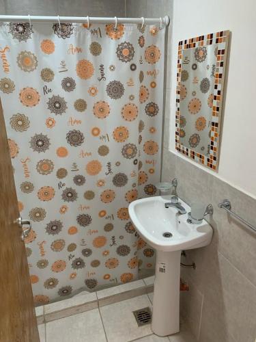 a bathroom with a sink and a shower curtain at Lo de Bruno in General Roca