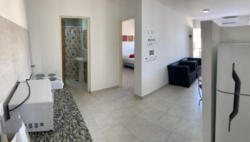 a hallway with a room with a couch and a room with a bedroom at Lo de Bruno in General Roca