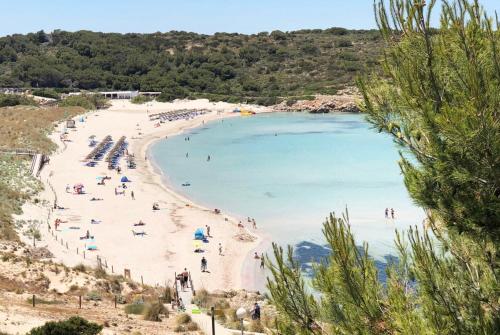 a beach with a bunch of people on it at FLAT Surrounded by Nature WIFI & Pool & beach Nearby in Son Parc