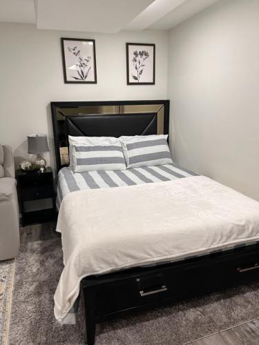 a bedroom with a large bed and a chair at Luxurious Basement Guest Suite in Elkridge in Elkridge