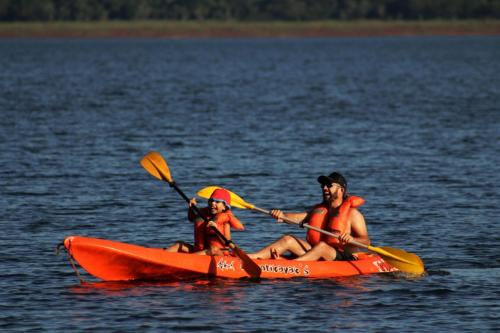 a man and a woman in a kayak on the water at Espacio Benignia in Puerto Libertad