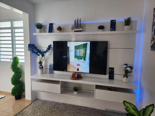 a living room with a tv on a white wall at Casita Kiri in San Sebastian