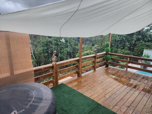 a wooden deck with a white umbrella on it at Casita Kiri in San Sebastian