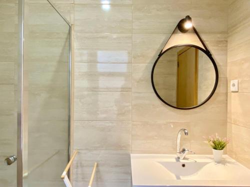 a bathroom with a sink and a mirror at Ady house in Setúbal