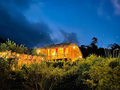 a train car sitting in a field at night at Pu Luong Cuisine Garden Homestay in Làng Bang