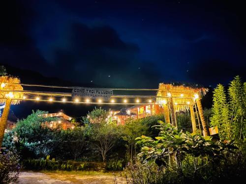 a night view of a building with lights at Pu Luong Cuisine Garden Homestay in Làng Bang