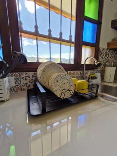 a kitchen counter with a sink with a banana on it at Hospedaje Resguardo Real in Ráquira