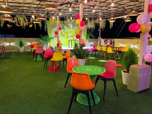 a group of tables and chairs in a room at The कस्तूरी in Maihar