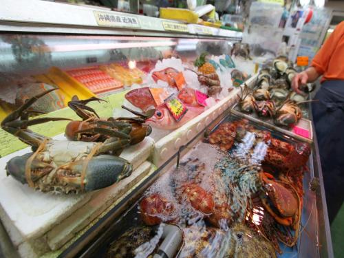 a display case with lobster and other seafood in a store at RJ Hotel Naha in Naha