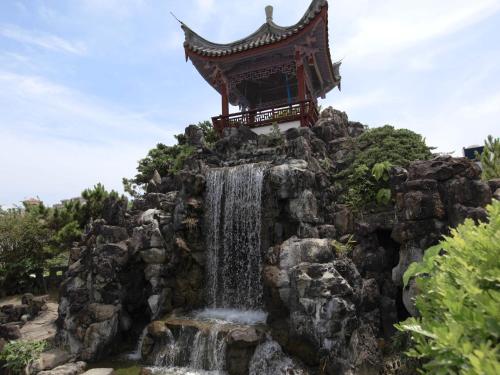 a shrine on top of a waterfall at RJ Hotel Naha in Naha