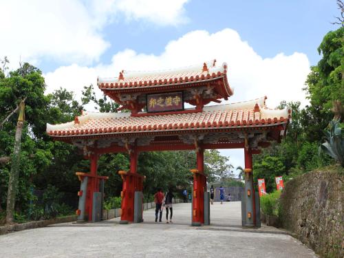 a gate in a park with people walking through it at RJ Hotel Naha in Naha