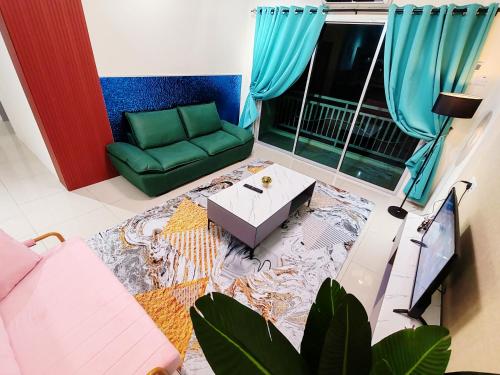 a living room with a green couch and a table at Pavilionvillie M1T692 by irainbow in Ipoh