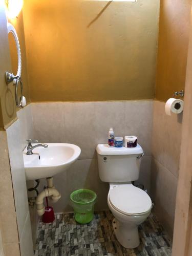 a bathroom with a toilet and a sink at 1 Bedroom Apartment in Curepe