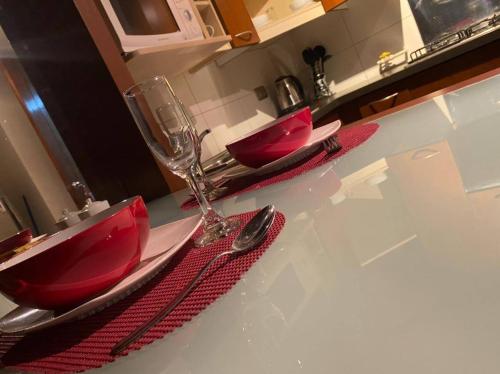 a kitchen counter with two red sinks in a kitchen at Departamentos Santiago in Santiago