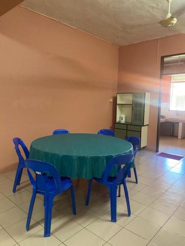 a blue table and chairs in a room at NaVita Homestay in Tamparuli