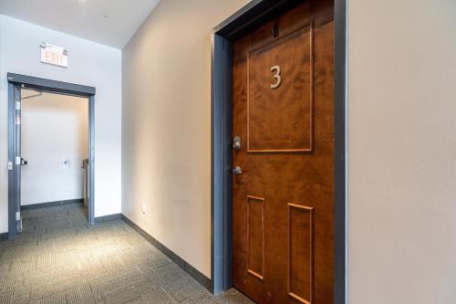 a door with the number three on it in a hallway at Bright & Charming Loft #3 in Halifax