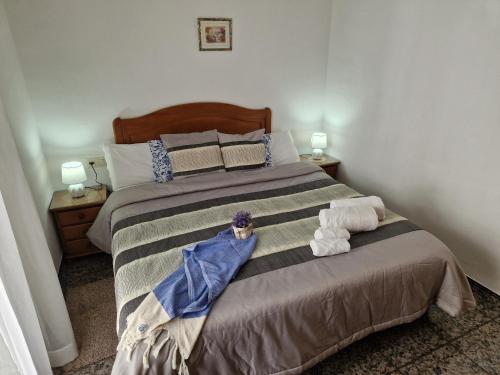 a bedroom with a bed with two stuffed animals on it at Casa Rural La Replaceta in Chulilla