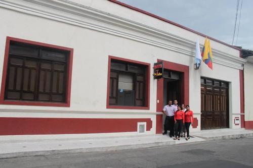 a group of people standing outside of a building at Hotel San Julian in Buga