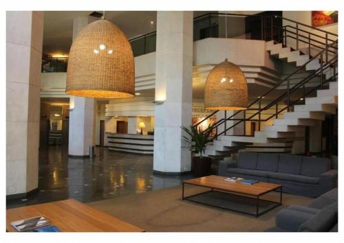 a lobby with two large chandeliers in a building at Suíte Aconchegante em Copacabana - Piscina, Wi-fi e perto da praia in Rio de Janeiro