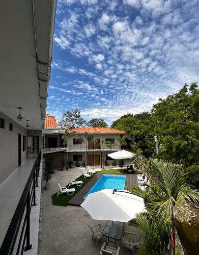 an external view of a house with a swimming pool at OCEAN DRIVE LODGE in Montañita