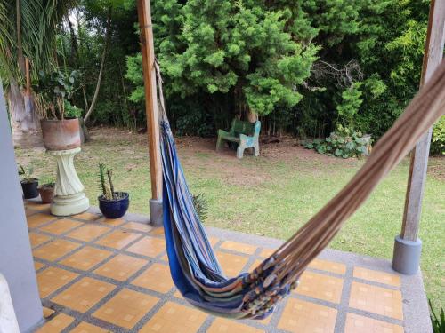 a hammock on a patio with a chair in a yard at Casa Vélez in Villamaría
