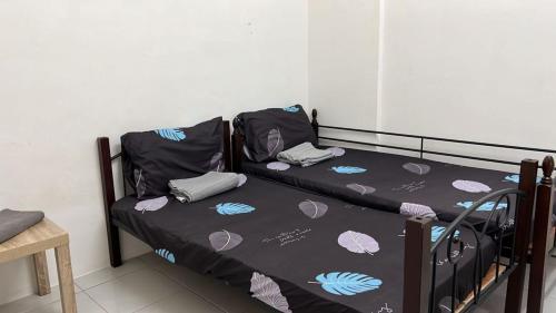 two bunk beds in a small room with at Camelia Homestay in Seri Iskandar