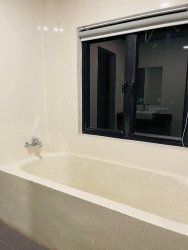a bathroom with a large window and a bath tub at Roya Khmer House in Siem Reap