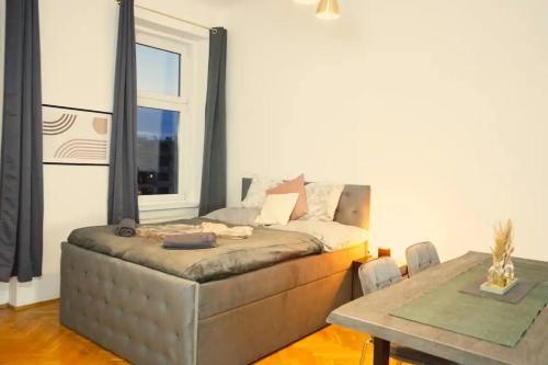 a living room with a couch and a table at City Nook Apartments Near Hauptbahnhof in Vienna