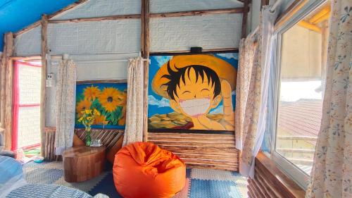 a room with a painting on the wall and a window at Long Vĩ hotel - đảo Phú Quý in Cu Lao Thu