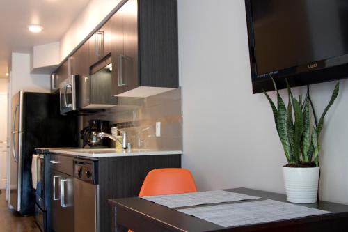 a kitchen with an orange chair and a kitchen counter at Amazing Capitol Hill Apartment with Free Parking! in Seattle