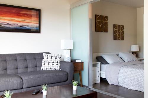 a living room with a couch and a bed at Amazing Capitol Hill Apartment with Free Parking! in Seattle