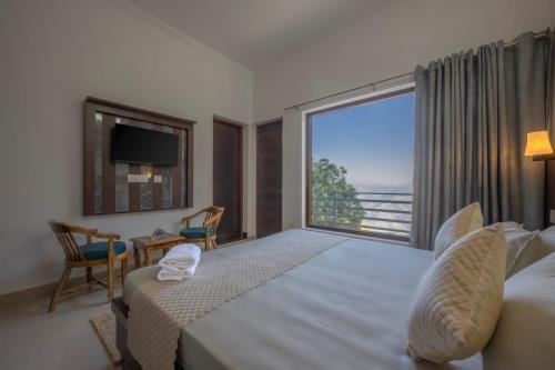 a bedroom with a large bed and a large window at Wonder Inn Kasauli in Kasauli