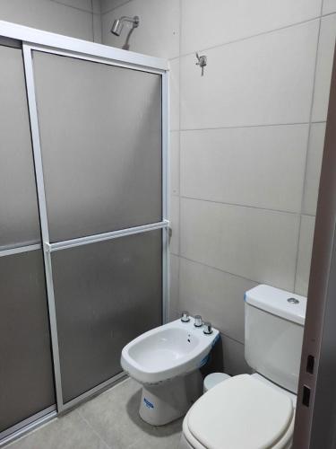 a bathroom with a shower and a toilet and a sink at Naturaleza Termal in Chajarí