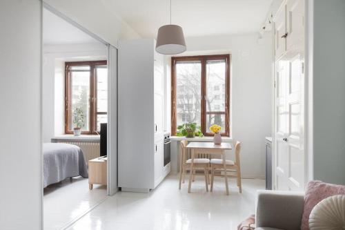 a bedroom with a bed and a table with a chair at Charming suite with garden views steps from metro in Helsinki